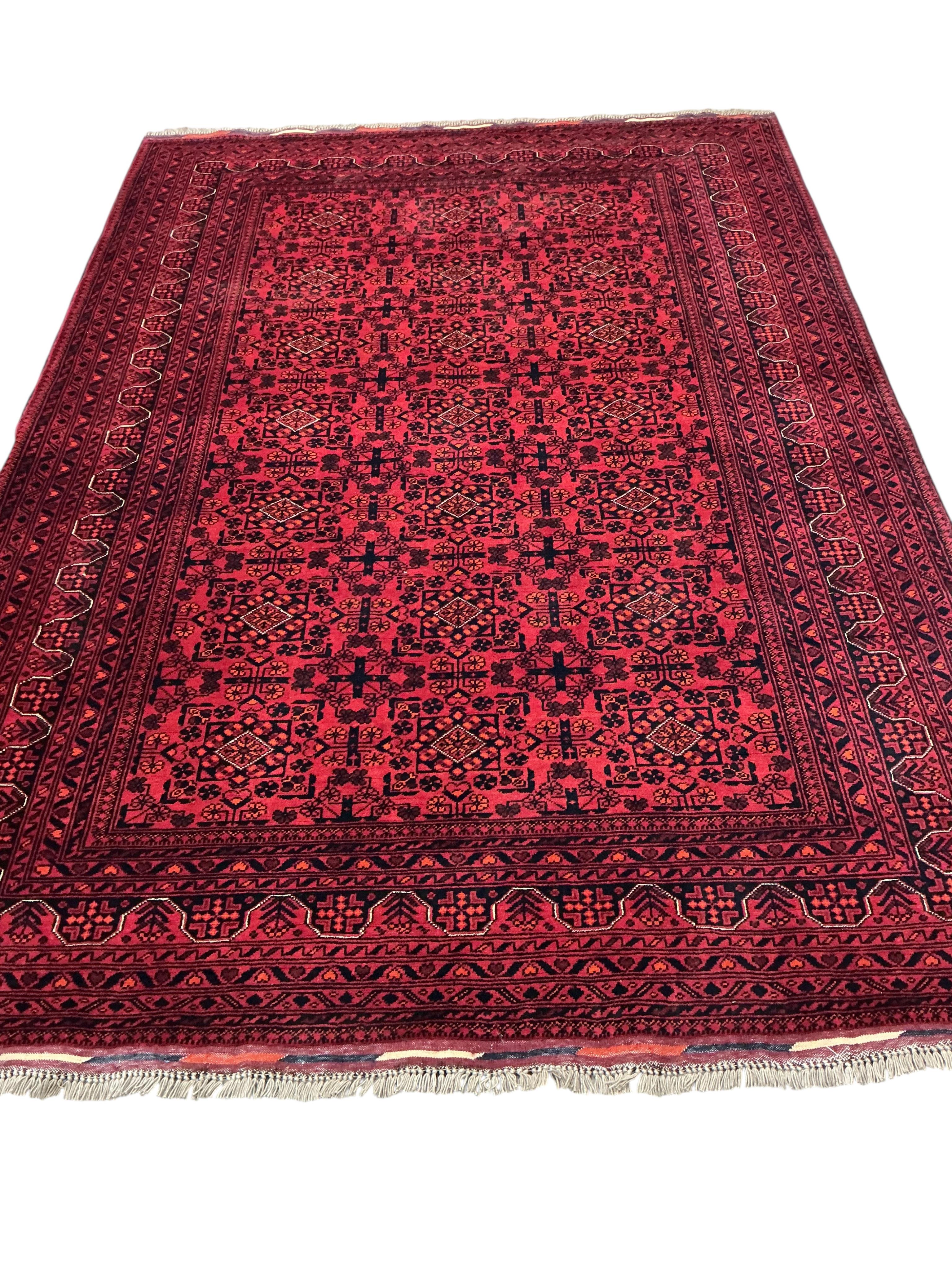 A Belouch red ground carpet, 240 x 170cm